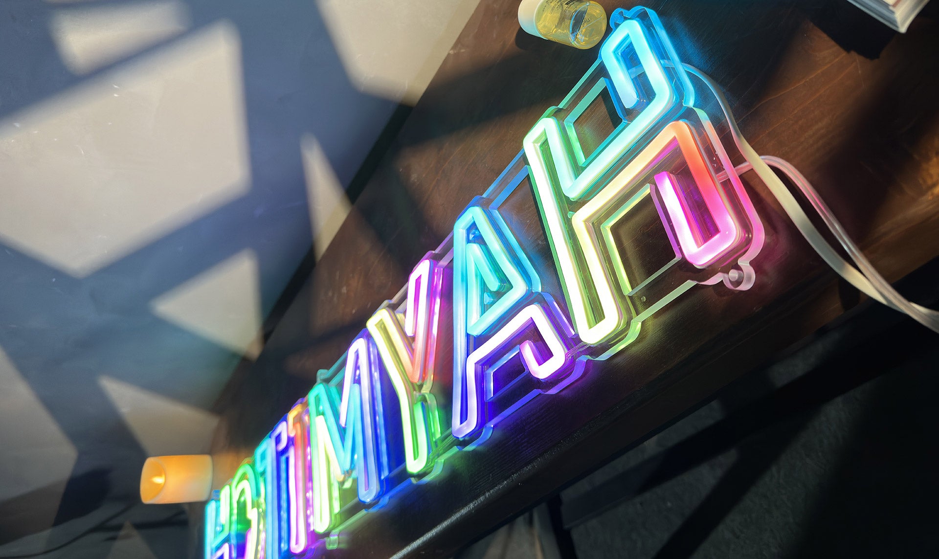 Neon sign with colorful letters on a dark background